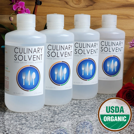 Pure Organic Perfumers Alcohol gallon by Culinary Solvent food grade ethanol with orchids, roses, and fresh flowers teak wood background