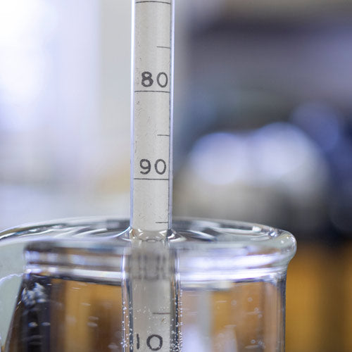 190 proof alcohol hydrometer floating in graduated cylinder