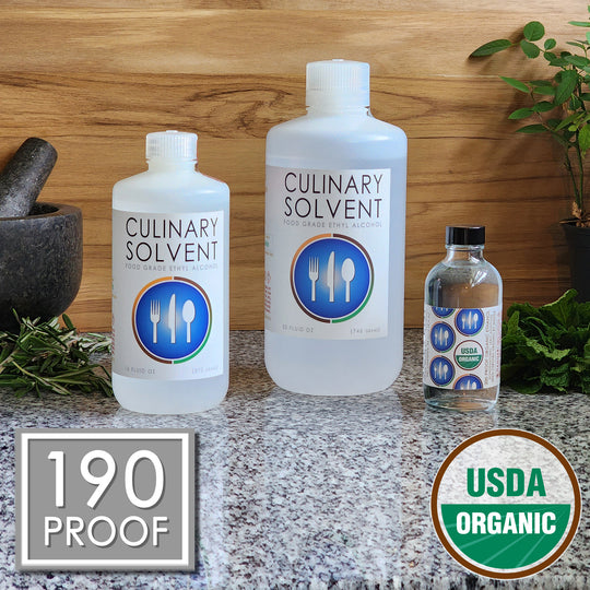 Pure USDA Organic Food Grade Ethanol by Culinary Solvent with rosemary, mint, and fresh herbs for tincture on teak wood background