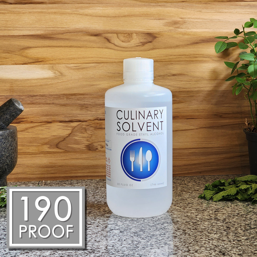 Pure 190 Proof Food Grade Ethanol quart by Culinary Solvent with rosemary, mint, and fresh herbs for tincture on teak wood background