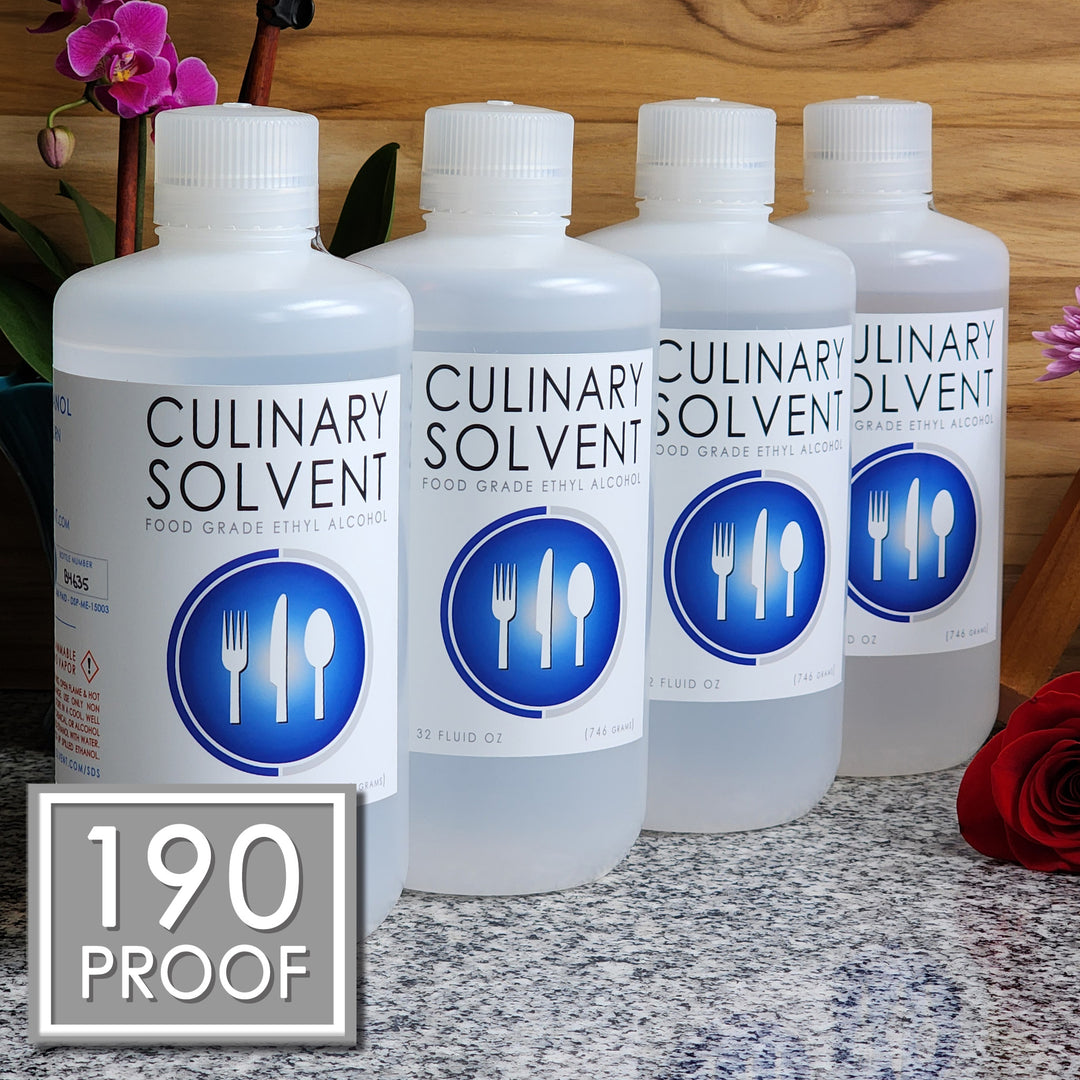 Pure Perfumers Alcohol gallon by Culinary Solvent food grade ethanol with orchids, roses, and fresh flowers teak wood background