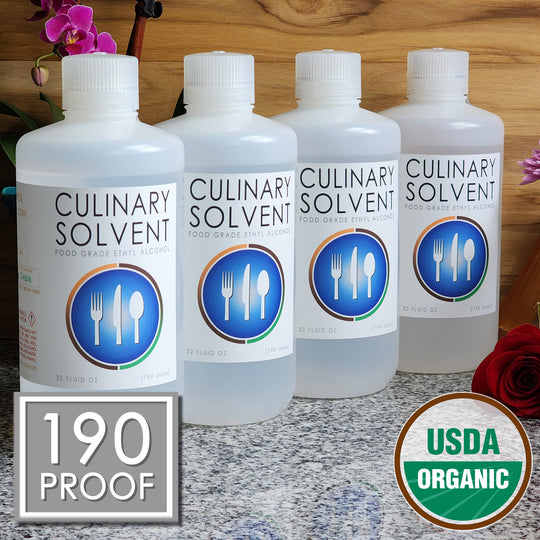 Pure Organic Perfumers Alcohol gallon by Culinary Solvent food grade ethanol with orchids, roses, and fresh flowers teak wood background